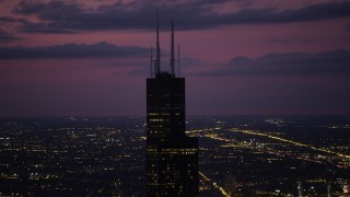 4.8K aerial stock footage of orbiting the top of Willis Tower, on a cloudy day at night, Downtown Chicago, Illinois Aerial Stock Footage | AX0003_149