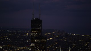 4.8K aerial stock footage of orbiting the top of Willis Tower, Downtown Chicago, Illinois, night Aerial Stock Footage | AX0003_151