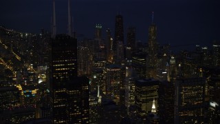 4.8K aerial stock footage approach Willis Tower and Downtown Chicago skyscrapers at night, and tilt down, Illinois Aerial Stock Footage | AX0003_154