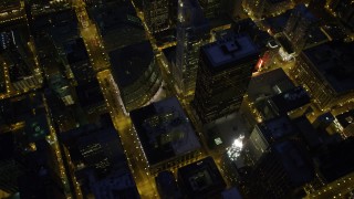 4.8K aerial stock footage of tilt from city streets revealing Chicago River and skyscrapers, at night, Downtown Chicago, Illinois Aerial Stock Footage | AX0003_156