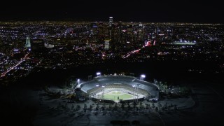 AX0004_035E - 5K aerial stock footage approach heavy traffic on Interstate 5, tilt to reveal stadium and downtown, Cypress Park, Los Angeles, California