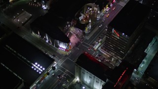 AX0004_079 - 5K aerial stock footage reverse view of Grauman's Chinese Theater on Hollywood Boulevard at night, California