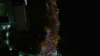 5K aerial stock footage bird's eye view of Wilshire Boulevard and reveal Interstate 405 at night, California Aerial Stock Footage | AX0004_091