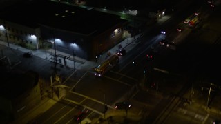 5K aerial stock footage of reverse view of a city street at night in Pacoima, California Aerial Stock Footage | AX0004_104