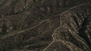 5K aerial stock footage of orbiting dirt roads up ridges in the San Gabriel Mountains, California Aerial Stock Footage | AX0005_015