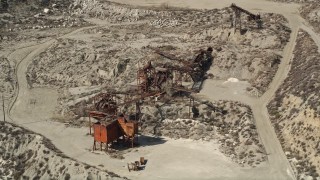 AX0005_019 - 5K aerial stock footage orbit quarry machinery in Santa Clarita, California