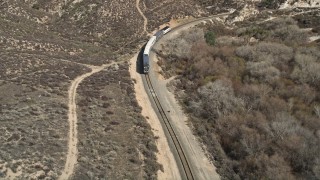 5K aerial stock footage reveal and approach passenger train in Santa Clarita, California Aerial Stock Footage | AX0005_024