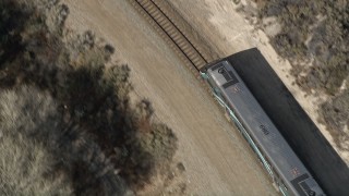 5K aerial stock footage of tracking the front of a commuter train in Santa Clarita, California Aerial Stock Footage | AX0005_027