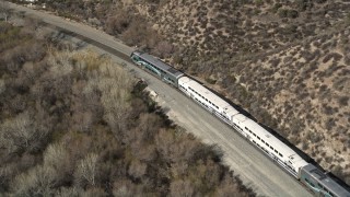 5K aerial stock footage track Metrolink train traveling near Santa Clarita, California Aerial Stock Footage | AX0005_028E