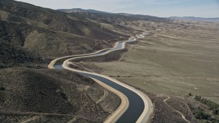 5K aerial stock footage fly low over the desert to reveal California Aqueduct in Mojave Desert Aerial Stock Footage | AX0005_063