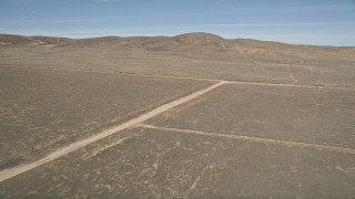 5K aerial stock footage approach and fly over dirt roads in the desert in Antelope Valley, California Aerial Stock Footage | AX0005_068