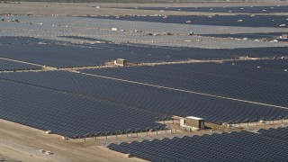 5K aerial stock footage orbit rows of panels at a massive solar array in the Mojave Desert, California Aerial Stock Footage | AX0005_084E