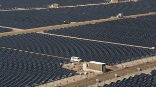 AX0005_086 - 5K aerial stock footage orbit rows of solar panels at an array in the Mojave Desert, California