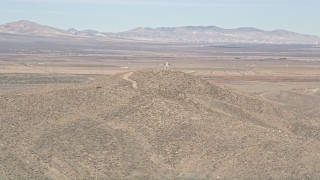 5K aerial stock footage of orbiting a building atop a desert mountain overlooking Antelope Valley, California Aerial Stock Footage | AX0005_096