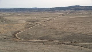 5K aerial stock footage orbit a dirt road through the desert in Antelope Valley, California Aerial Stock Footage | AX0005_098