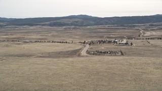 5K aerial stock footage video of approach rural desert homes in Antelope Valley, California Aerial Stock Footage | AX0005_101