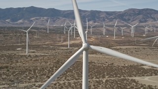 5K aerial stock footage orbit of a windmill at a desert wind farm in Antelope Valley, California Aerial Stock Footage | AX0005_131E