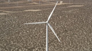 5K aerial stock footage of a windmill with spinning blades in the Mojave Desert, California Aerial Stock Footage | AX0005_135