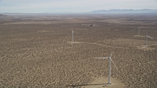 5K aerial stock footage of a small group of windmills at a Mojave Desert wind farm in California Aerial Stock Footage | AX0005_140