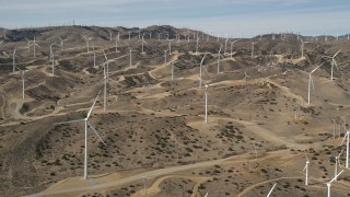 5K aerial stock footage approach large group of windmills at desert wind energy farm in Antelope Valley, California Aerial Stock Footage | AX0006_019