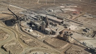 AX0006_038 - 5K aerial stock footage orbit quarry buildings in the Mojave Desert, California