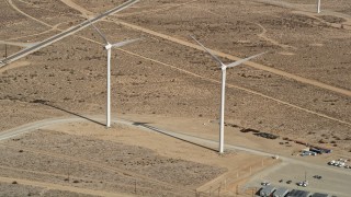 5K aerial stock footage approach two windmills at a wind energy farm in the California desert Aerial Stock Footage | AX0006_045E