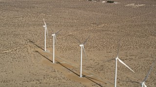 5K aerial stock footage approach four windmills at a desert wind farm in Antelope Valley, California Aerial Stock Footage | AX0006_051