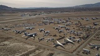 5K aerial stock footage orbiting an aircraft boneyard in the Mojave Desert, California Aerial Stock Footage | AX0006_061E