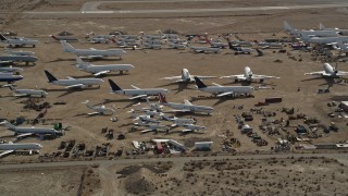 5K aerial stock footage orbiting jet aircraft at an airplane boneyard in the Mojave Desert, California Aerial Stock Footage | AX0006_063