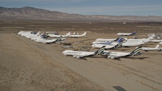 5K aerial stock footage of jet aircraft at a desert boneyard in California's Mojave Desert Aerial Stock Footage | AX0006_068