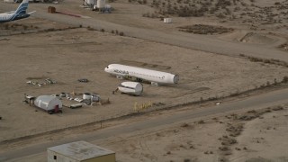 AX0006_073 - 5K aerial stock footage orbit the cabin part of an airplane at a boneyard in the California desert, Mojave Air and Space Port