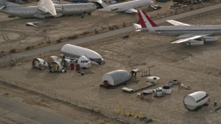 5K aerial stock footage orbit cabin and cockpit aircraft sections at a desert boneyard, Mojave Air and Space Port, California Aerial Stock Footage | AX0006_074