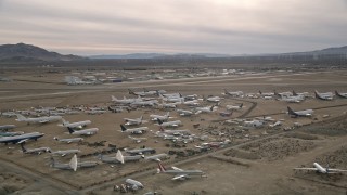 5K aerial stock footage circle over planes at an aircraft boneyard in the Mojave Desert, California Aerial Stock Footage | AX0006_082E