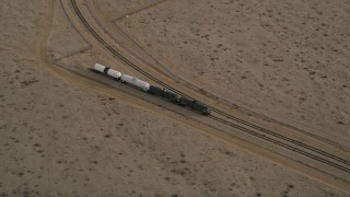 5K aerial stock footage approach tanker train on a side track in Mojave, California Aerial Stock Footage | AX0006_097