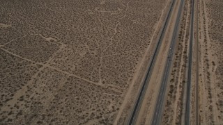 5K aerial stock footage reverse view of a Highway 14 and open desert in Antelope Valley, California Aerial Stock Footage | AX0006_099