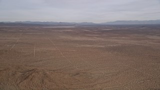 5K aerial stock footage pan across open desert and mountains in the Mojave Desert, California Aerial Stock Footage | AX0006_118