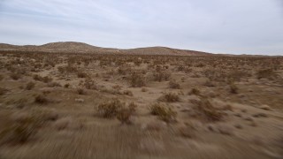 5K aerial stock footage fly fast and low over desert vegetation and hills in the Mojave Desert, California Aerial Stock Footage | AX0006_141E