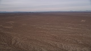 5K aerial stock footage pan across open desert to reveal the small town of Helendale, California Aerial Stock Footage | AX0006_155