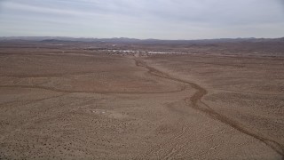 5K aerial stock footage pan across the Mojave Desert to reveal the small town of Helendale, California Aerial Stock Footage | AX0006_156