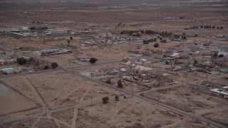 AX0007_014E - 5K aerial stock footage fly over rural homes in the small desert town of Victorville, California at Sunset