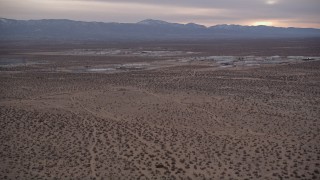 5K aerial stock footage tilt and reveal warehouse buildings at Sunset in Victorville, California Aerial Stock Footage | AX0007_016