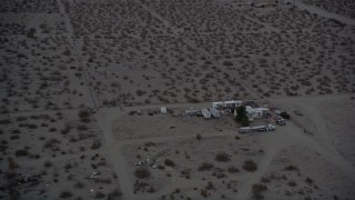 5K aerial stock footage tilt and fly over RVs parked in the Mojave Desert at twilight, California Aerial Stock Footage | AX0007_024