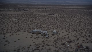 5K aerial stock footage orbiting small desert home in Mojave Desert, California at twilight Aerial Stock Footage | AX0007_025