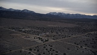 5K aerial  video approach and tilt to isolated home in the Mojave Desert at twilight, California Aerial Stock Footage | AX0007_039