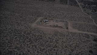 5K aerial stock footage orbit a small group of RVS in the Mojave Desert at twilight, California Aerial Stock Footage | AX0007_040