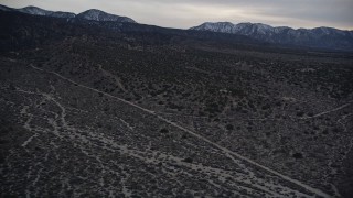 5K aerial stock footage of flying over rural homes in the Mojave Desert at twilight, California Aerial Stock Footage | AX0007_041