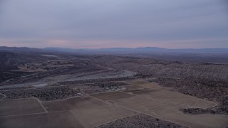 5K aerial stock footage approach a dry riverbed at twilight in the Mojave Desert, California Aerial Stock Footage | AX0008_002