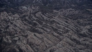 5K aerial stock footage fly over rock formations at base of San Gabriel Mountains at twilight, California Aerial Stock Footage | AX0008_005