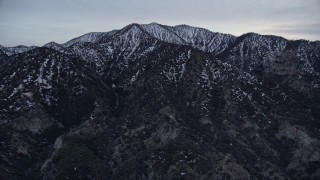 5K aerial stock footage approach snowy ridges in the San Gabriel Mountains in winter at twilight, California Aerial Stock Footage | AX0008_006