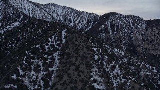 5K aerial stock footage flyby snowy ridges in the San Gabriel Mountains at twilight in winter, California Aerial Stock Footage | AX0008_008